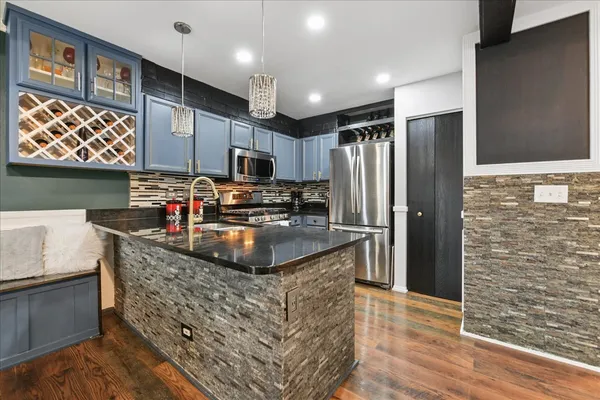 a kitchen with stainless steel appliances and cabinets