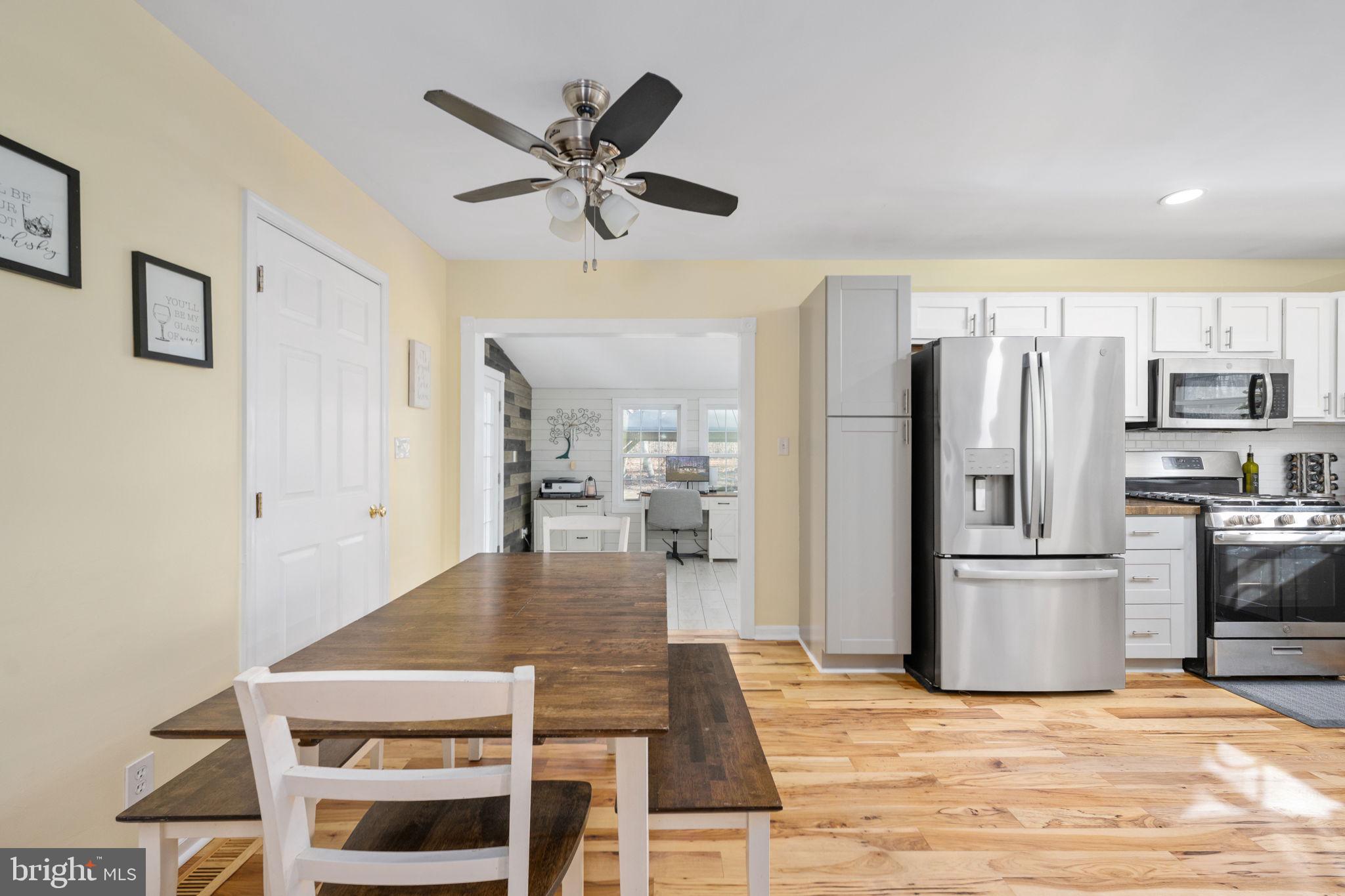 435 Halls Store Road Mineral, VA 23117 - Photo 20 of 59 a view of a kitchen with kitchen island a stove a refrigerator cabinets and wooden floor