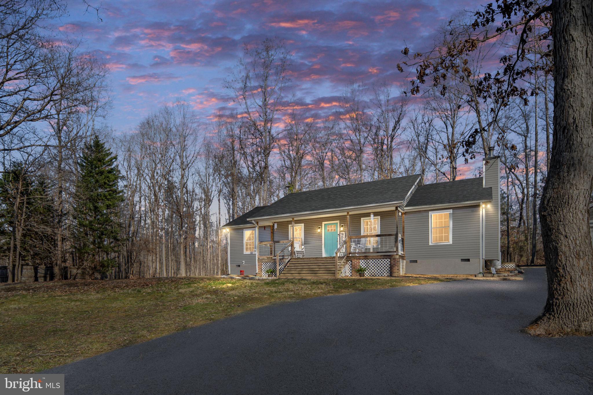 435 Halls Store Road Mineral, VA 23117 - Photo 3 of 59 a front view of a house with a garden and tree