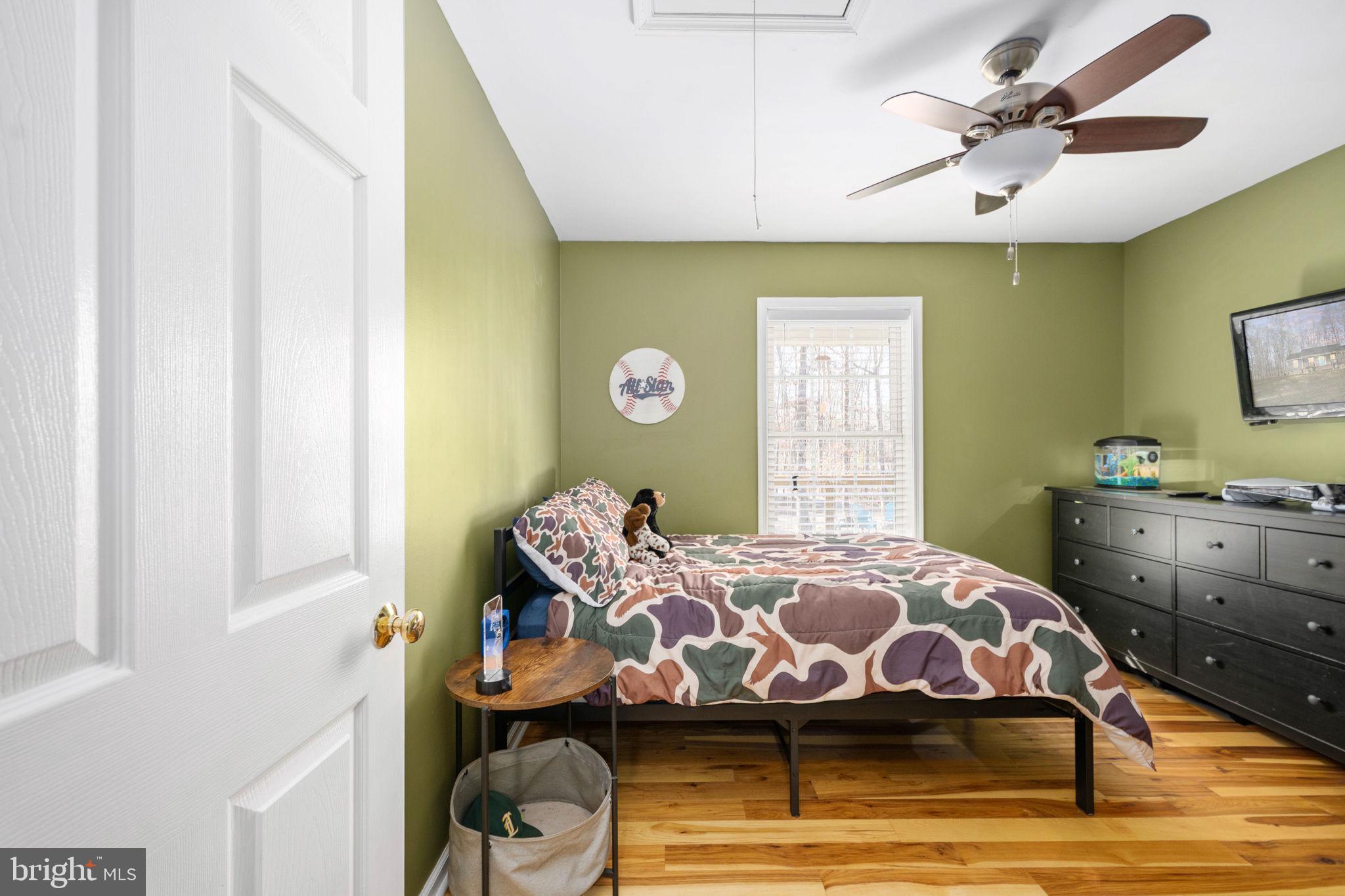 435 Halls Store Road Mineral, VA 23117 - Photo 31 of 59 a bedroom with a bed and wooden floor