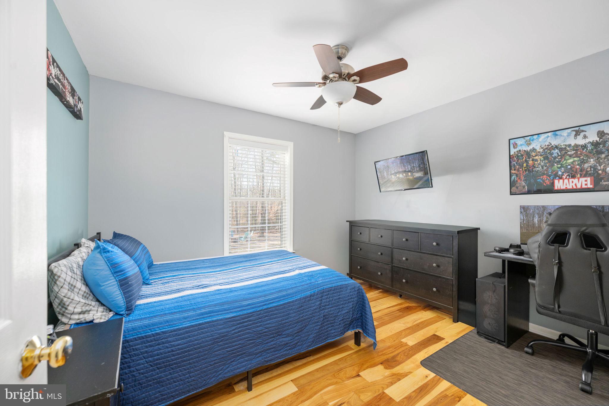 435 Halls Store Road Mineral, VA 23117 - Photo 36 of 59 a bedroom with a bed and wooden floor