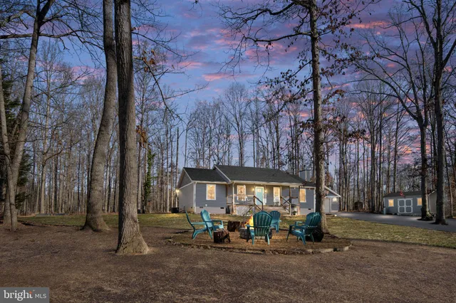 a view of a house with a yard and sitting area