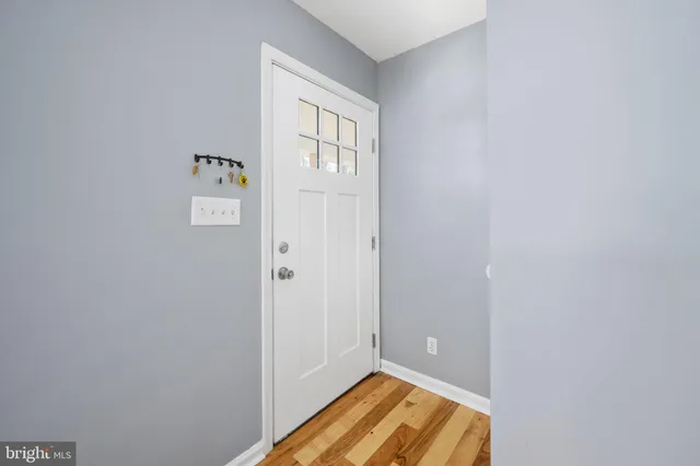 a view of a house with a yard and large tree