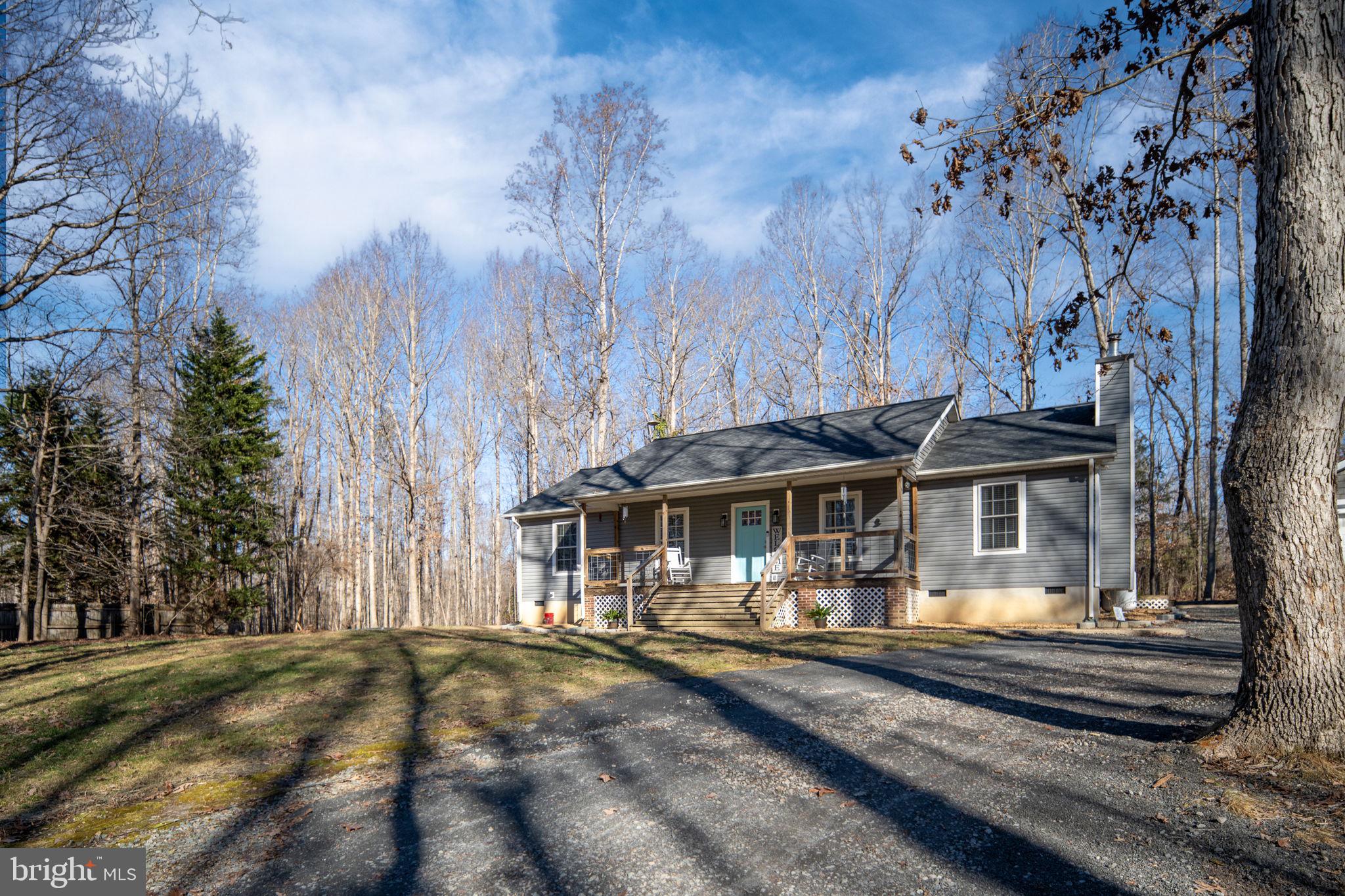 435 Halls Store Road Mineral, VA 23117 - Photo 10 of 59 a view of a house with a yard patio and fire pit