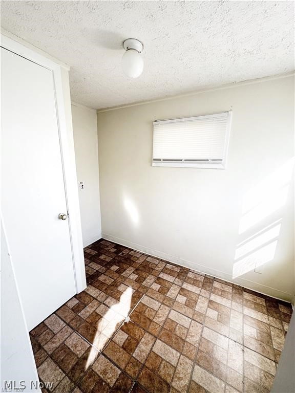 4643 Horton Road Cleveland, OH 44125 - Photo 17 of 21 Tiled spare room with a textured ceiling
