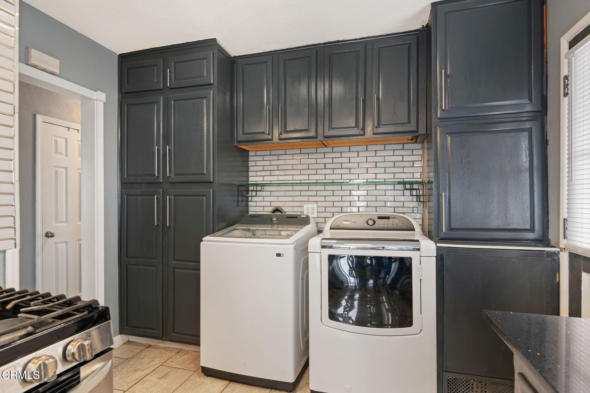 309 Rosa Street West Oxnard, CA 93033 - Photo 11 of 18 a kitchen with a stove and a refrigerator
