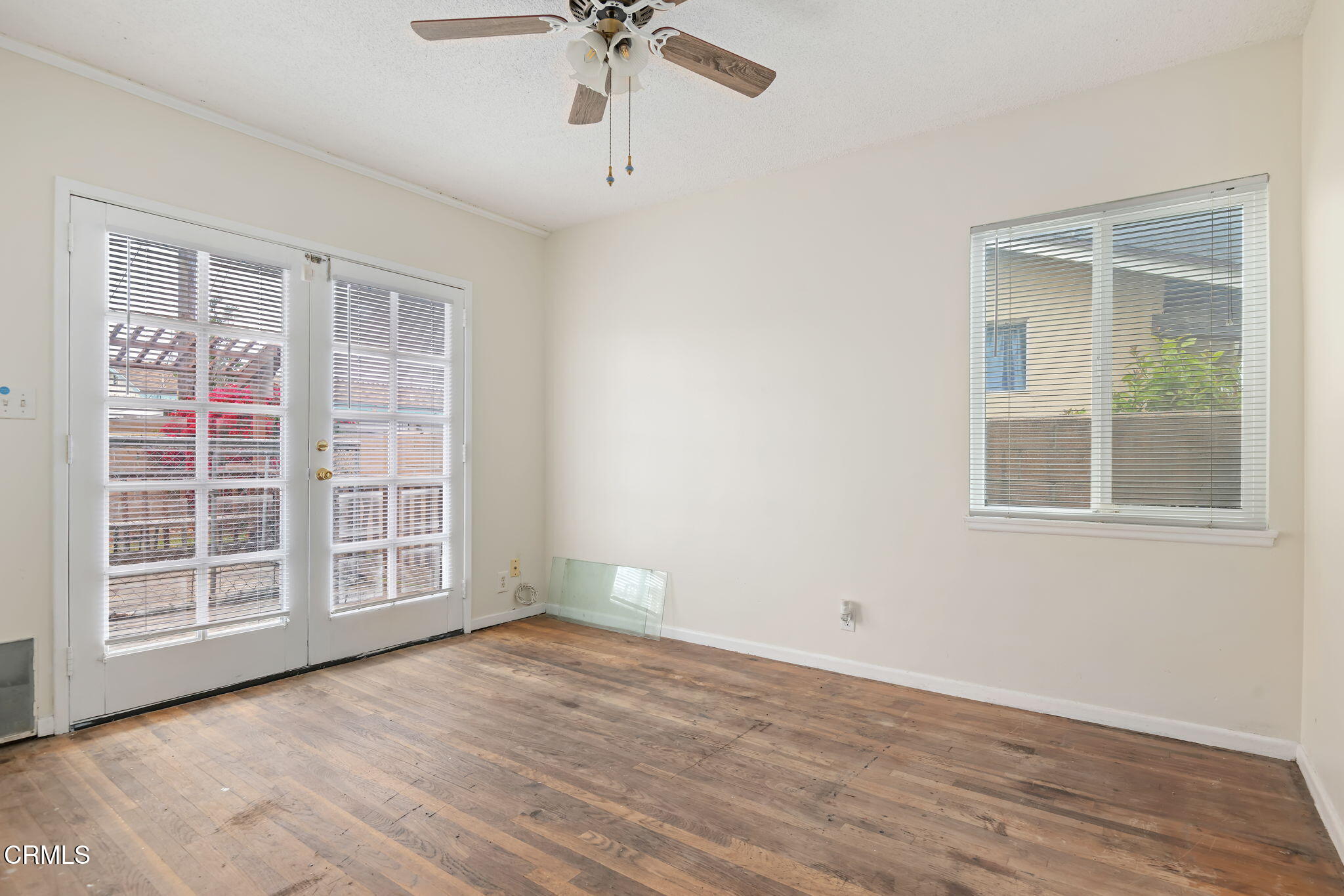 309 Rosa Street West Oxnard, CA 93033 - Photo 15 of 18 a view of an empty room with a window and wooden floor