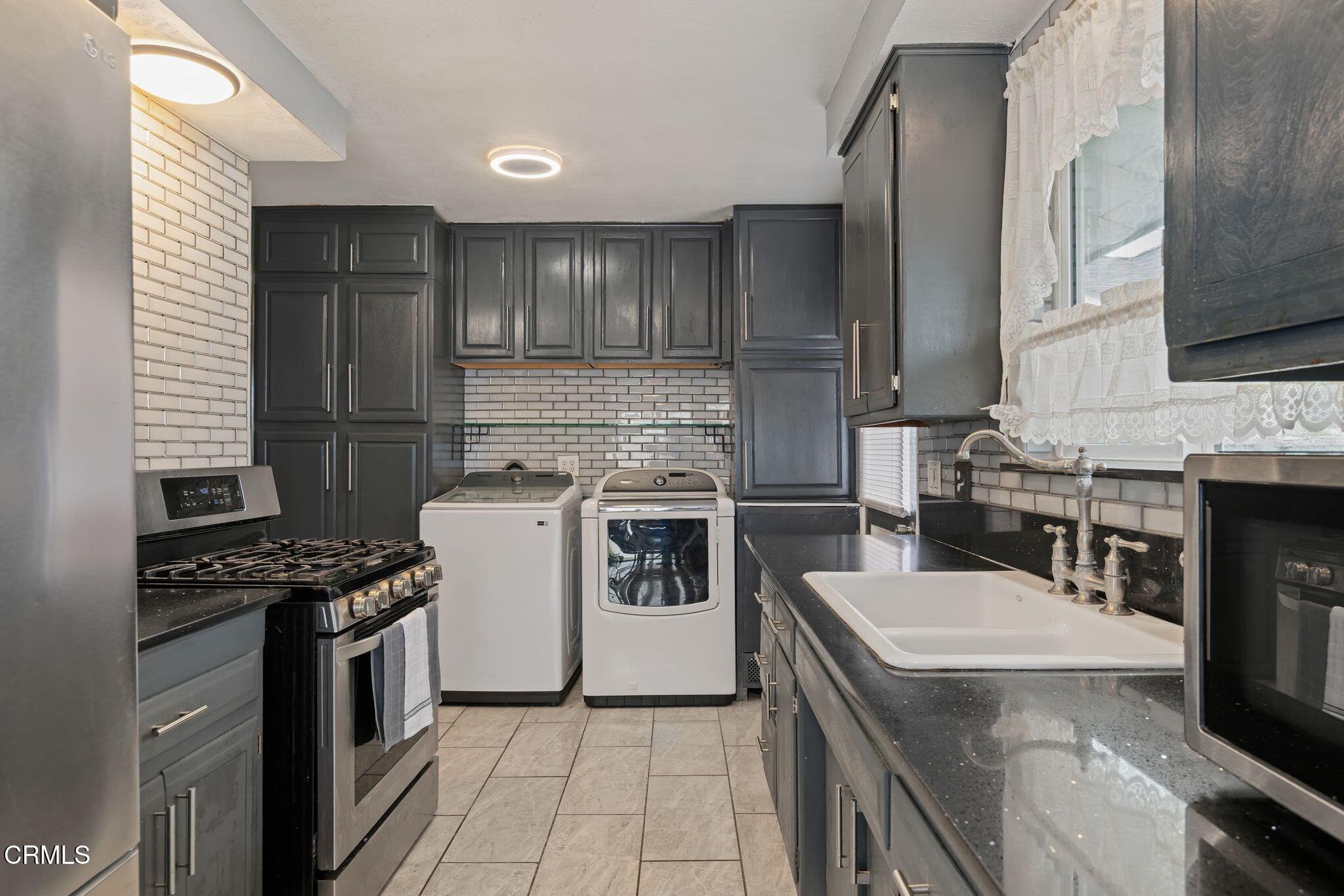 309 Rosa Street West Oxnard, CA 93033 - Photo 9 of 18 a kitchen with a stove and a refrigerator