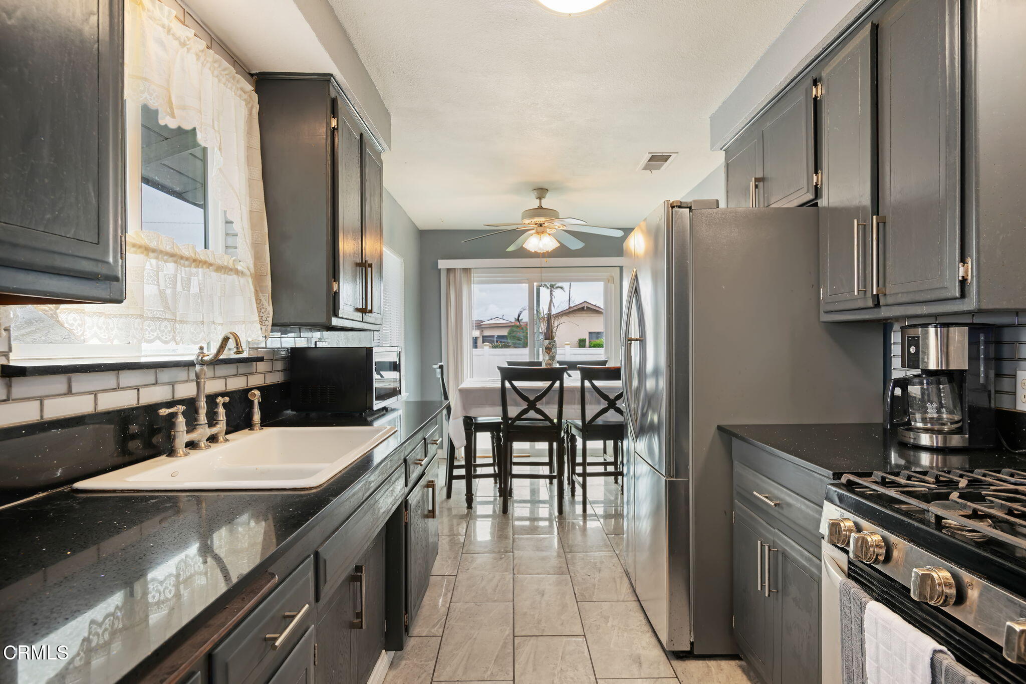 309 Rosa Street West Oxnard, CA 93033 - Photo 10 of 18 a kitchen with granite countertop a sink appliances and cabinets