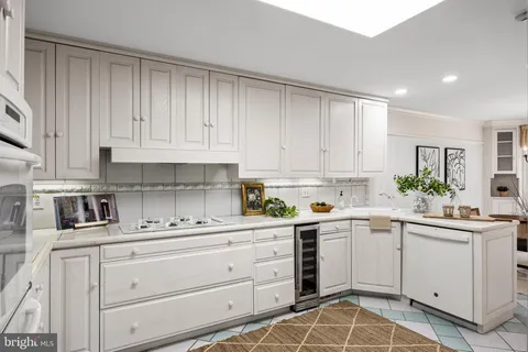 a kitchen with white cabinets stainless steel appliances and sink