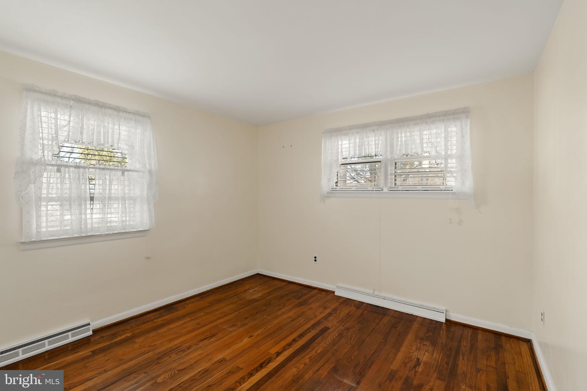 406 South Church Street Quarryville, PA 17566 - Photo 11 of 24 an empty room with wooden floor and windows