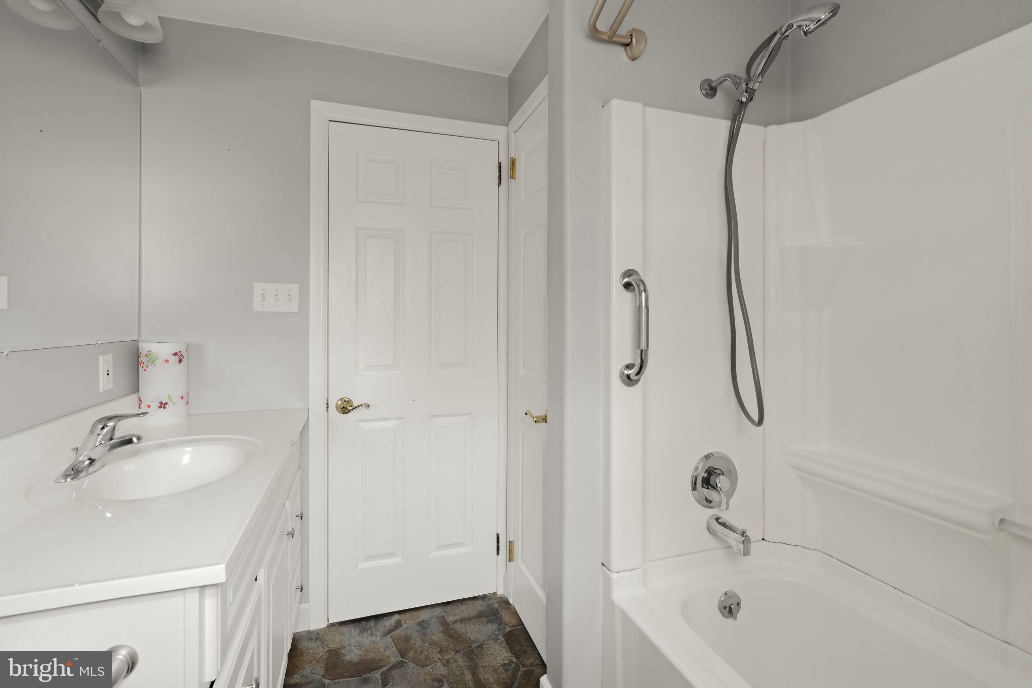 406 South Church Street Quarryville, PA 17566 - Photo 13 of 24 a bathroom with a tub sink vanity and shower