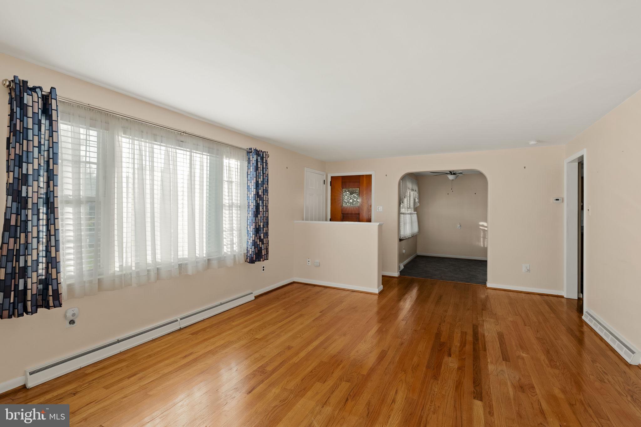 406 South Church Street Quarryville, PA 17566 - Photo 3 of 24 an empty room with wooden floor and windows