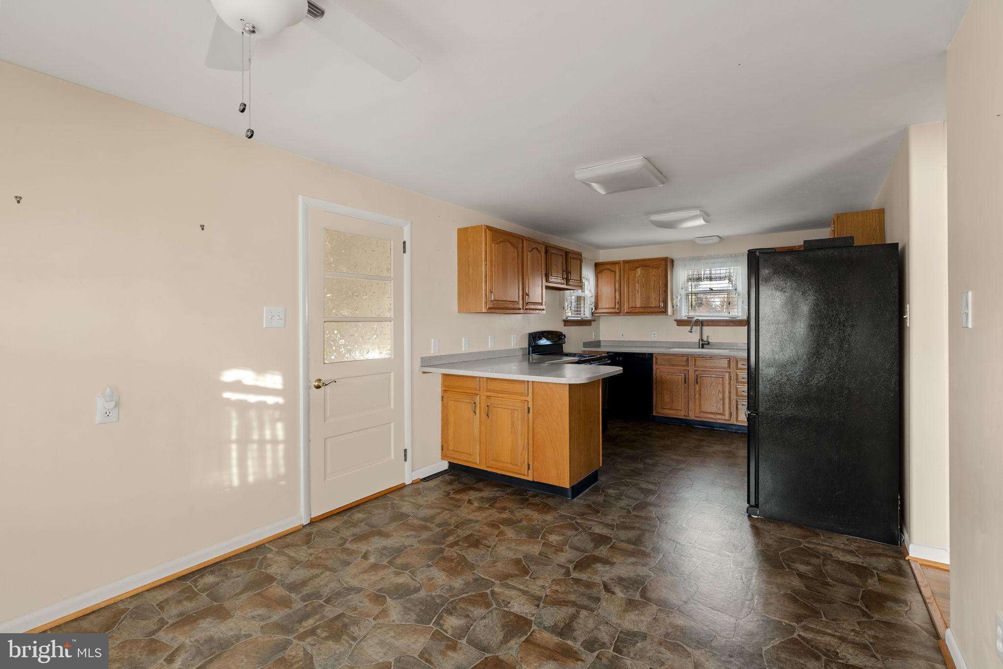406 South Church Street Quarryville, PA 17566 - Photo 4 of 24 a kitchen with stainless steel appliances granite countertop a refrigerator a sink dishwasher and a stove with kitchen island