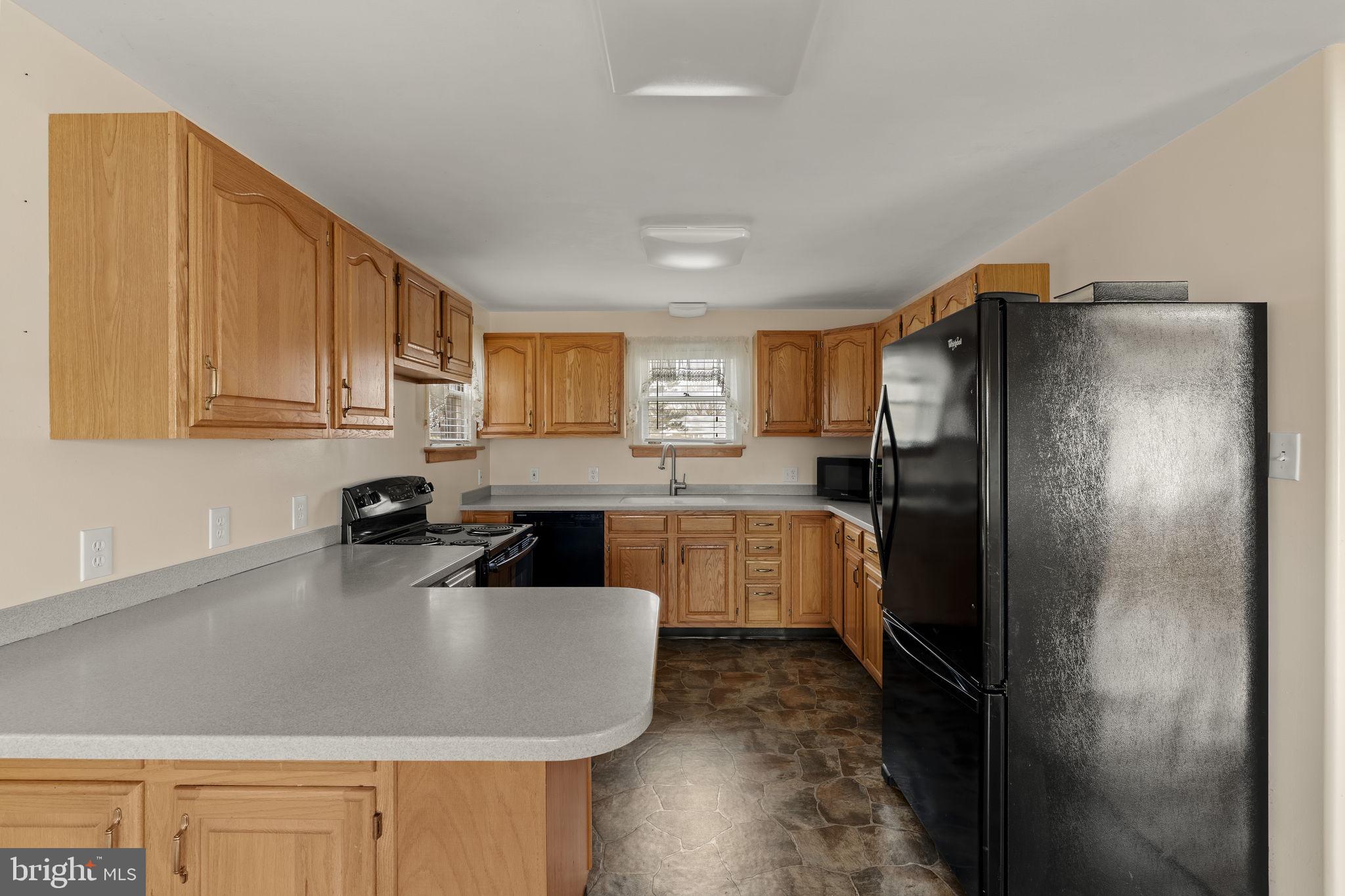 406 South Church Street Quarryville, PA 17566 - Photo 5 of 24 a kitchen with stainless steel appliances granite countertop a refrigerator and a sink