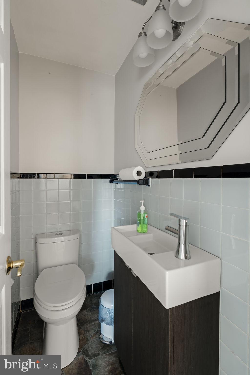 406 South Church Street Quarryville, PA 17566 - Photo 8 of 24 a bathroom with a sink a toilet and mirror