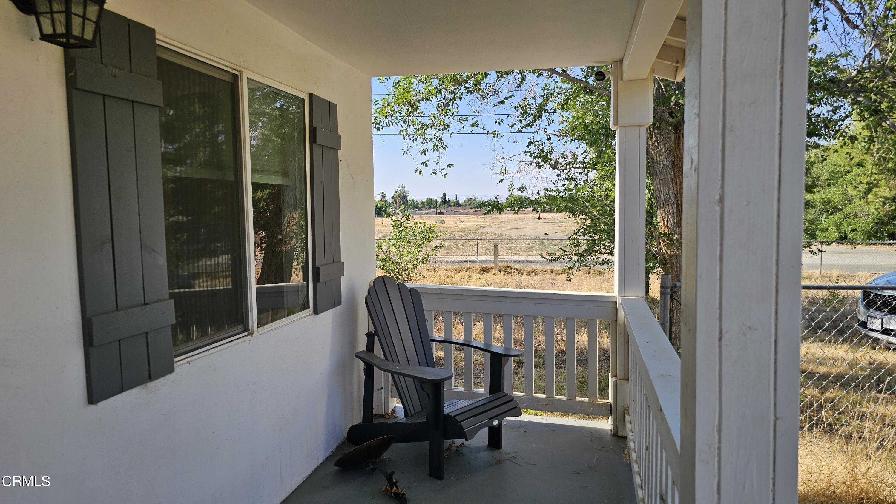 1032 West Newgrove Street Lancaster, CA 93534 - Photo 2 of 13 a view of a chairs and table in a balcony
