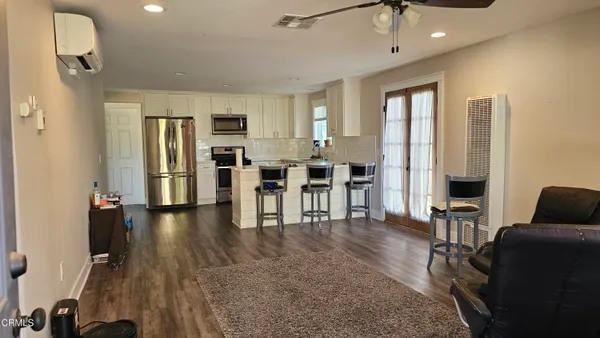 a view of a livingroom with furniture and an entryway