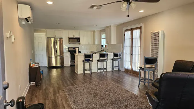a view of a livingroom with furniture and an entryway