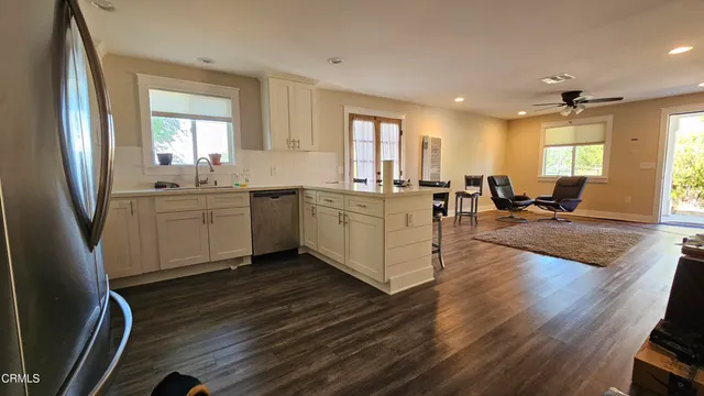 a large room with lots of counter space and windows