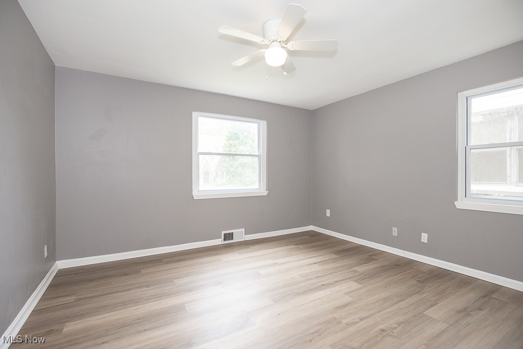 1547 Genesee Road South Euclid, OH 44121 - Photo 13 of 36 Empty room with light wood-style floors, baseboards, and ceiling fan