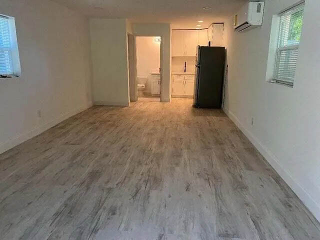 a view of a refrigerator in kitchen and wooden floor