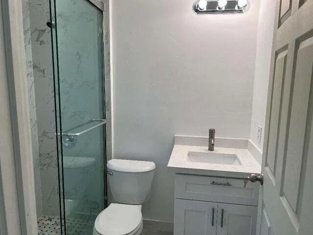 a bathroom with a sink toilet and shower