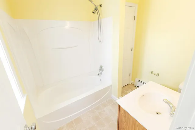 a bathroom with a bathtub and shower