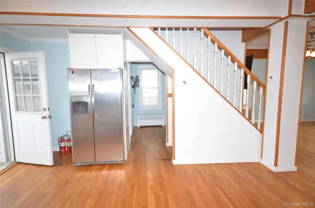 a view of an entryway with wooden floor