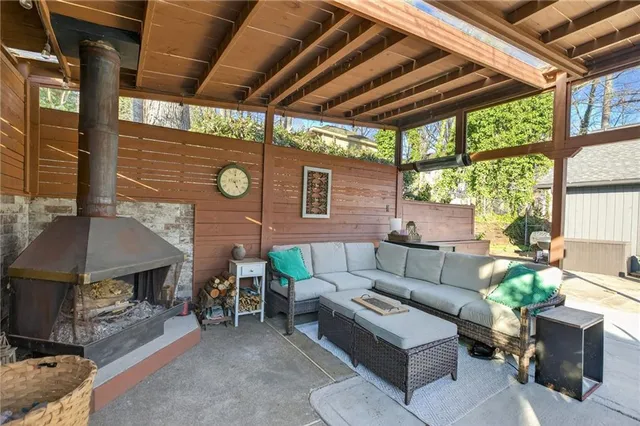 a outdoor living space with furniture and a fireplace