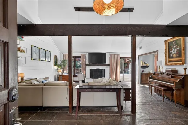 a living room with furniture and flat screen tv