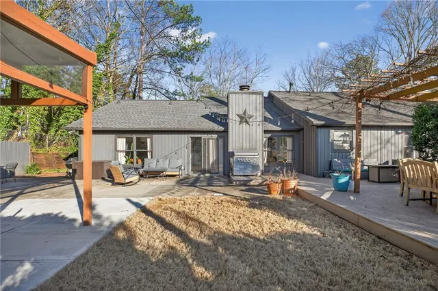 a view of a house with backyard and sitting area