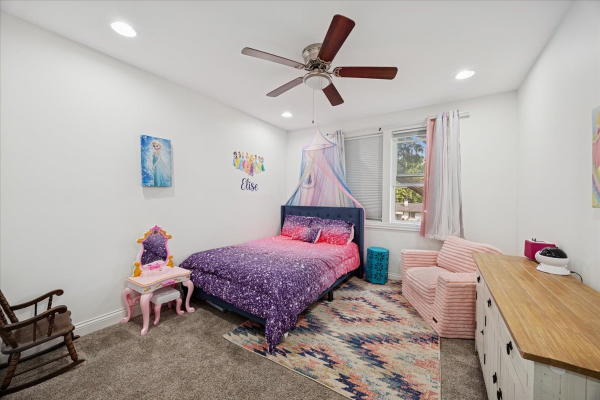 3931 Maple Avenue Brookfield, IL 60513 - Photo 14 of 24 a bedroom with a bed and a chandelier