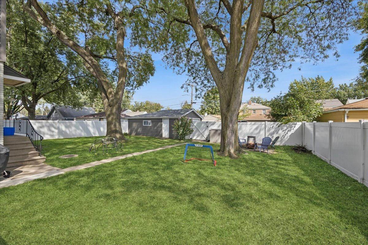 3931 Maple Avenue Brookfield, IL 60513 - Photo 21 of 24 a view of a house with backyard and a tree