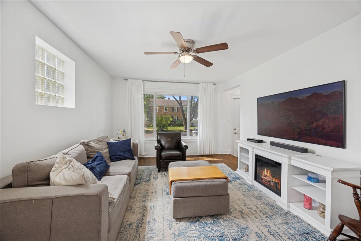 3931 Maple Avenue Brookfield, IL 60513 - Photo 4 of 24 a living room with furniture a flat screen tv and a fireplace
