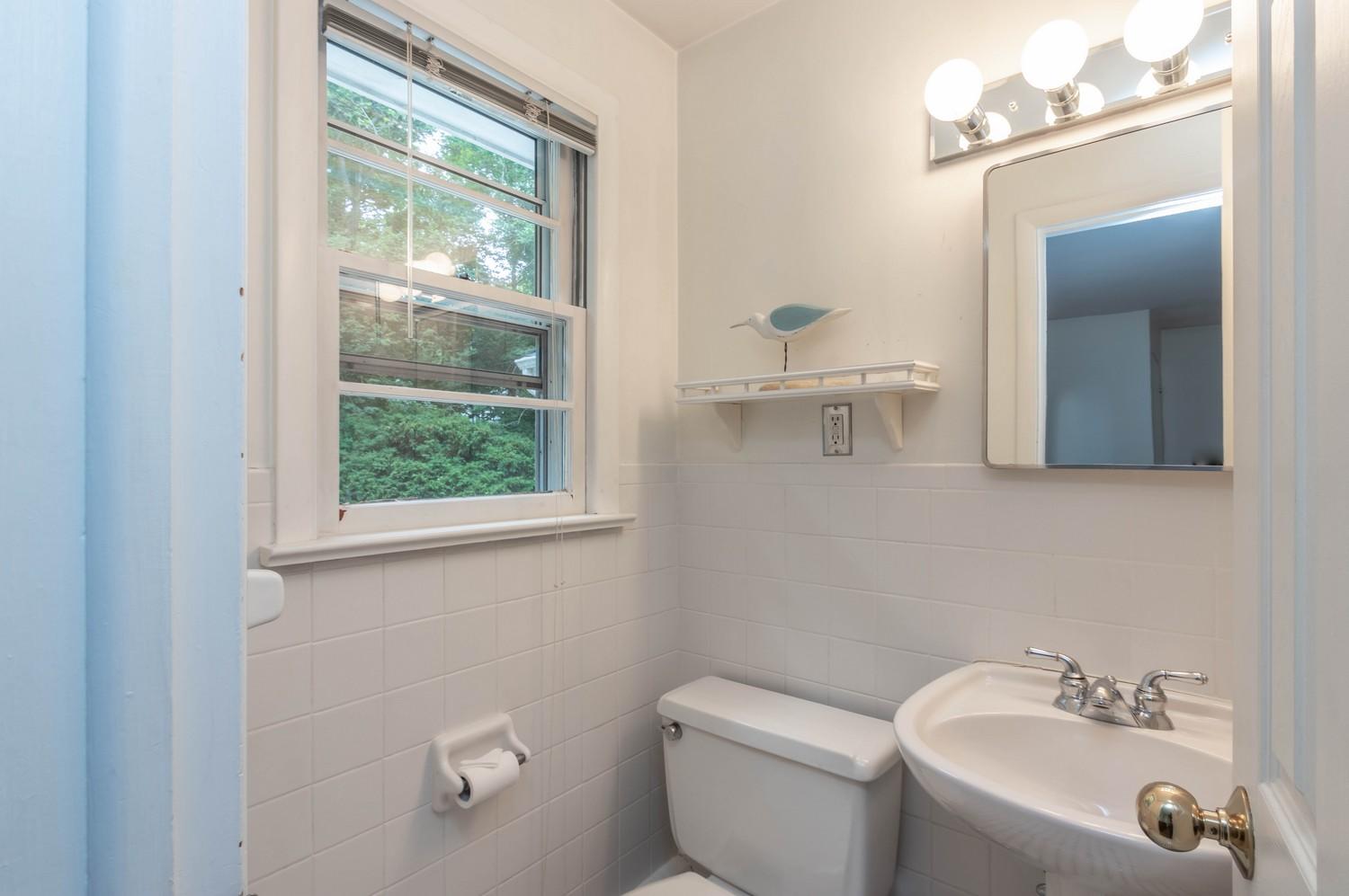 9 Sheffield Road Norwalk, CT 06853 - Photo 23 of 29 a bathroom with a toilet a sink a window and mirror