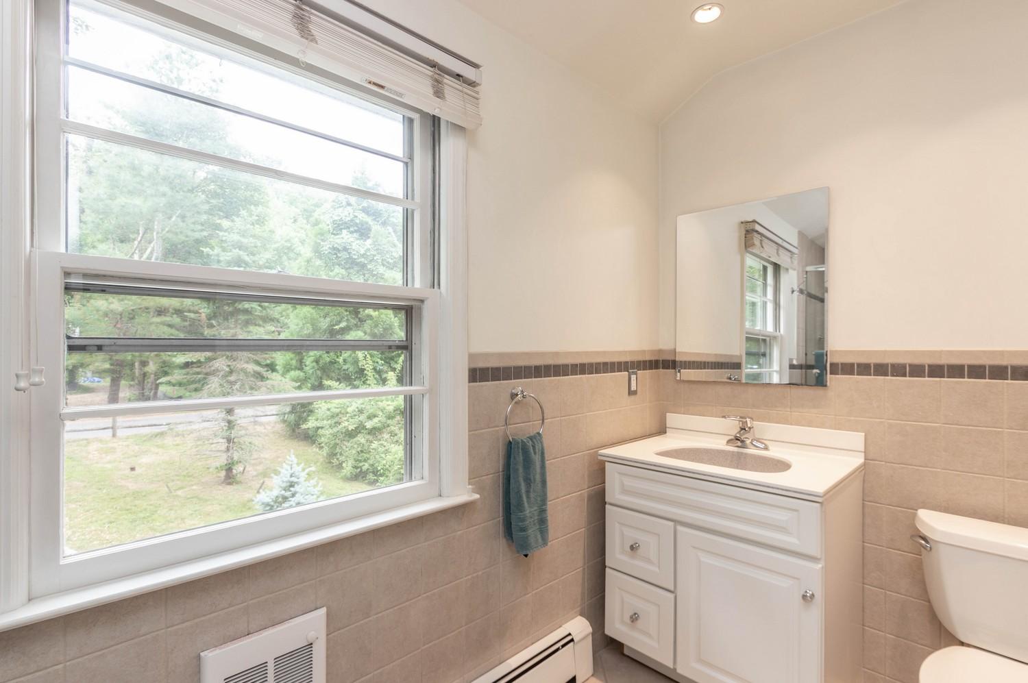 9 Sheffield Road Norwalk, CT 06853 - Photo 28 of 29 a bathroom with a granite countertop sink toilet a mirror and a window