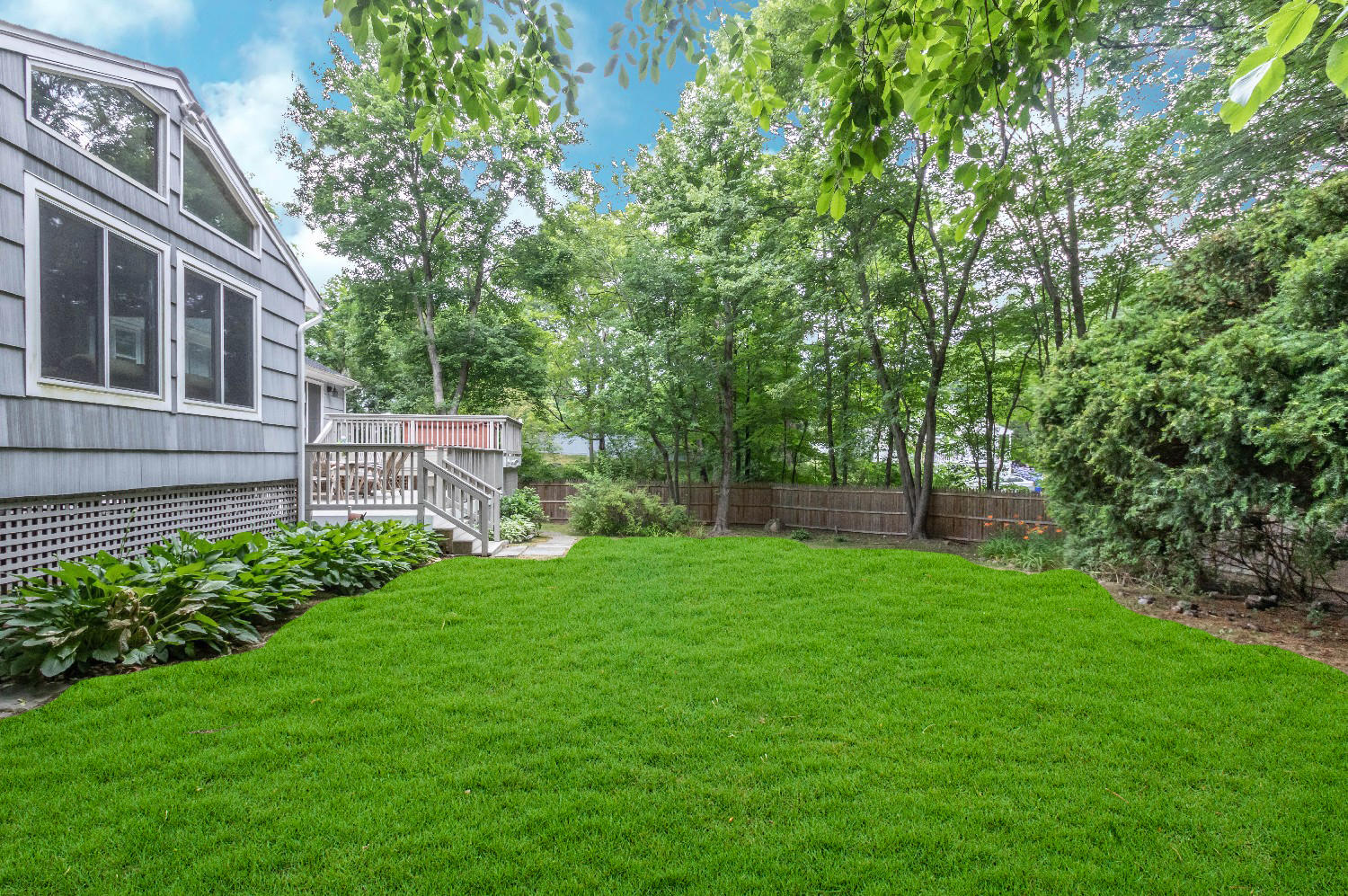9 Sheffield Road Norwalk, CT 06853 - Photo 7 of 29 a view of a backyard with plants and large trees