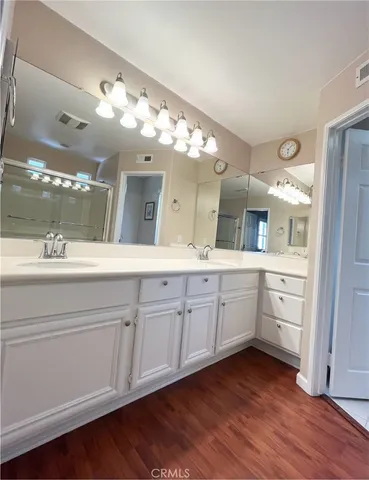 a spacious bathroom with a double vanity sink and a mirror