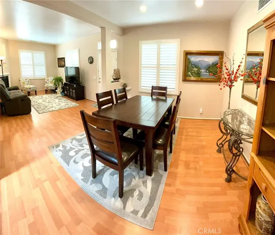 a living room with dining room and wooden floor