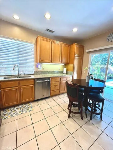 a kitchen with stainless steel appliances a sink a counter top space and a window