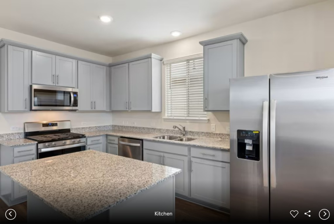 396 Begonia Street Buda, TX 78610 - Photo 6 of 10 a kitchen with stainless steel appliances granite countertop a sink stove and refrigerator