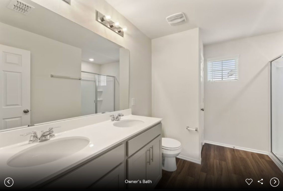 396 Begonia Street Buda, TX 78610 - Photo 8 of 10 a bathroom with a double vanity sink toilet and a mirror