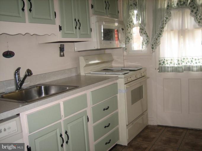 8352 Edgedale Road Parkville, MD 21234 - Photo 12 of 14 a kitchen with stainless steel appliances granite countertop a sink and a stove