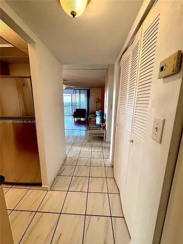 a view of a entryway door of the house and living room