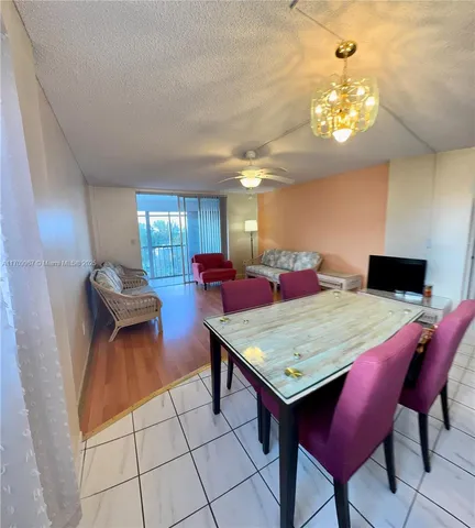 a room with furniture a chandelier and pool table