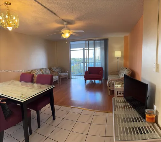 a living room with furniture and a dining table