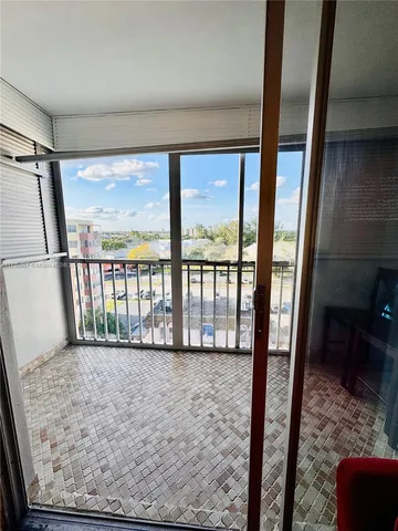 a large bed sitting in a room next to a lamp