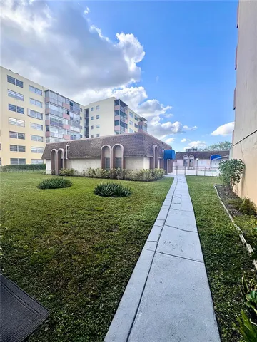 a view of a building with a yard