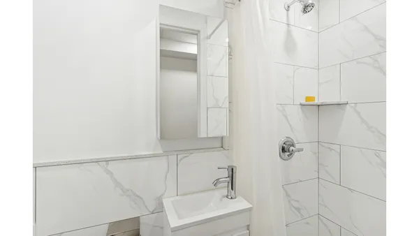 a bathroom with a sink and shower